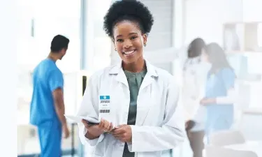 Illinois DNP nurse executive smiling with patient charts in hospital